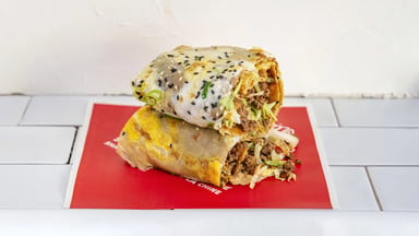 Minced beef jianbing with fermented black beans, cut in two on the house paper
